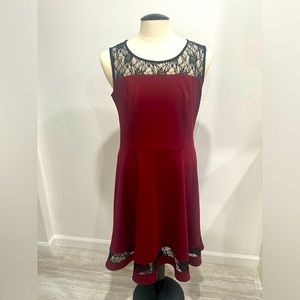 Sleeveless wine colored dress with black lace detail.